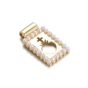 Detailed view of 18K gold rectangle pendant featuring white pearls and cross-heart design