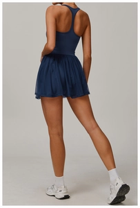Detail view of the back design on navy blue athletic two-piece tennis dress with mesh skirt