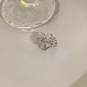 Detail of silver vine ring featuring micro-paved cubic zirconia in elegant leaf pattern