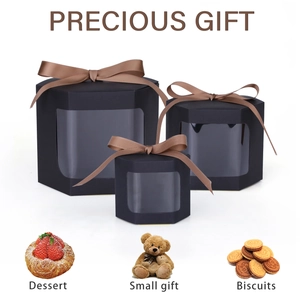 Three-piece black hexagonal gift boxes with clear windows and brown satin ribbons