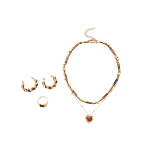 Tiger eye stone jewelry set with gold necklace, C-shaped earrings and ring on white backdrop