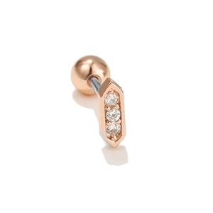 Macro detail of geometric rose gold cartilage stud with three inlaid zircon stones