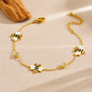 Gold-plated bee chain bracelet with white enamel charms and sparkling crystals