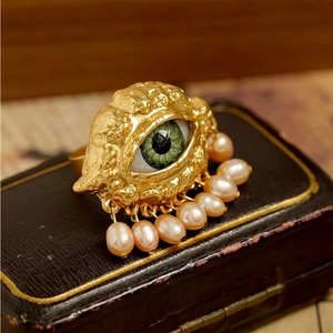 Vintage golden Evil Eye ring with a vibrant green pupil and dangling pink pearls decor