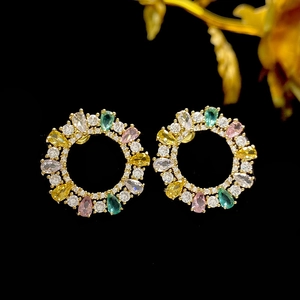Detailed macro view of colorful zircon crystals set in a luxury gold wreath earring