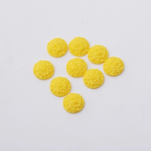 Close-up of 12mm yellow resin cabochons with sparkling druzy texture for jewelry making