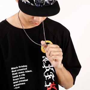 Detail of silver stainless steel box chain necklace worn by male model on black t-shirt