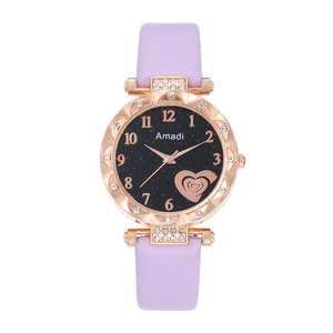 Detail of starry dial watch with heart motif, crystal bezel, and purple strap