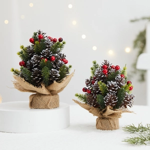 Mini Christmas pine tree set with cones and red berries on a burlap base for tabletop decor