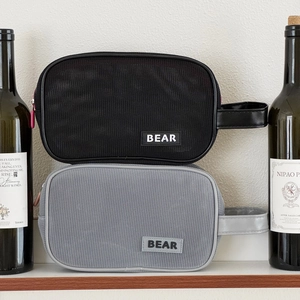 Close-up of mesh makeup bags with zip closure and BEAR label in black and grey