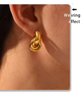 Wearing effect of golden multi-loop intertwined knot earrings in 18K gold plated steel