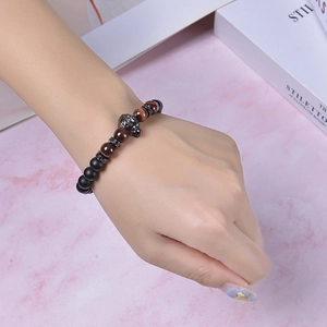 Wolf head tiger eye and matte black stone beaded bracelet for men on wrist