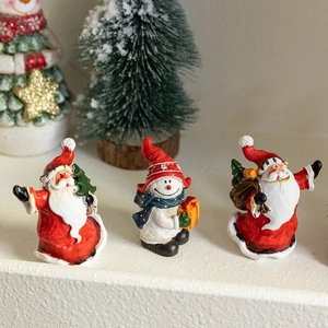 Miniature Christmas resin figurines featuring Santa Claus and snowman for holiday table decor