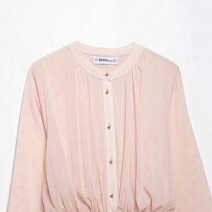 Pink pleated long-sleeve midi dress with gold collar buckle and matching belt detail