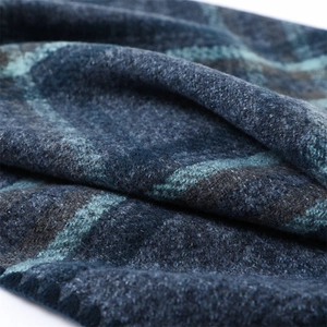 Macro texture of navy blue and cyan striped knit scarf showing soft cashmere feel