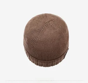 Top view of dark brown knit beanie showing ribbed texture and radial crown stitching