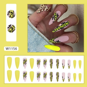 Long stiletto press-on nails with yellow leopard print and black leaf pattern art