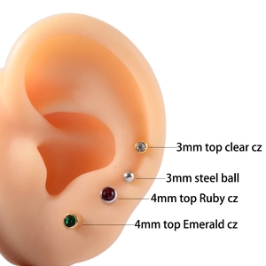 Macro detail of 3mm and 4mm CZ ear studs displayed on silicone ear model