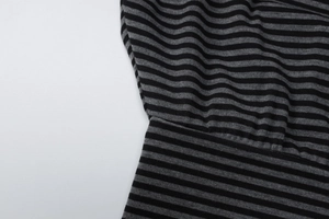 Macro shot of black and gray striped knit fabric showing fine texture and sewing detail