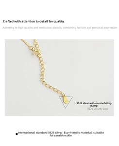 Macro shot of S925 sterling silver stamp on a gold-plated necklace teardrop tag