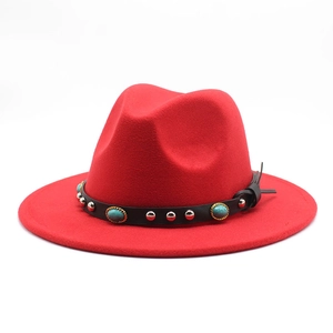 Detail of red fedora hat featuring black leather belt with turquoise and silver studs