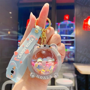 Detail of blue liquid candy koala keychain with glitter sequins and rubber strap