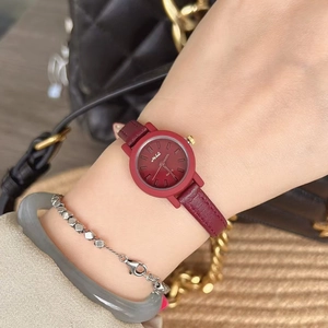 Elegant ladies quartz watch with burgundy leather strap and round dial on female wrist