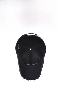 Detail showing the inner structure, brand label, and distressed brim of the black baseball cap