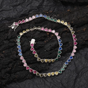 Colorful heart-shaped zircon tennis necklace with silver-tone metal base on dark stone