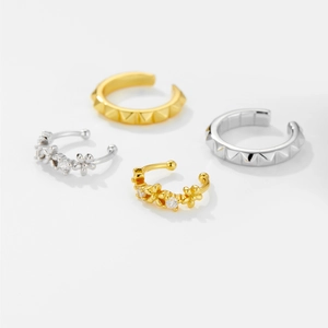 Detail of S925 silver ear cuff set featuring pyramid studs and zircon flowers