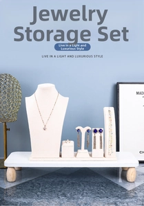 Detail view of premium beige velvet jewelry display set with a wooden base on blue background