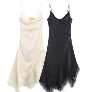 Detail of satin slip dresses in champagne and black with delicate lace trim and cowl neck