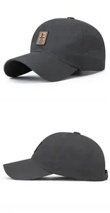 Close-up of laser-cut breathable holes and brown leather patch on a grey baseball cap