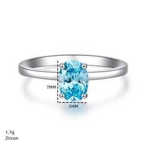 Macro shot of 7x5mm oval blue zircon on silver ring showing 1.7g weight and dimensions