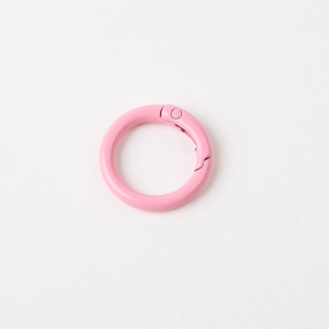 Close-up of pink round metal spring ring gate for bags and keychain accessories