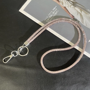 Detail of sparkling pink rhinestone lanyard with silver metal clasp on black leather