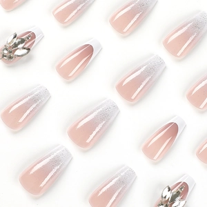 French tip press-on nails with rhinestones and silver glitter in coffin shape