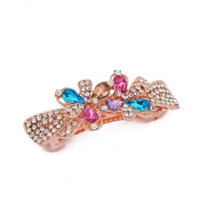 Macro view of rose gold alloy hair clip with colorful rhinestones in bow design