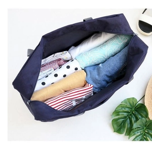 Foldable navy travel duffel bag showing high capacity storage for organized clothes