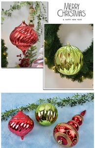 Close-up of red and green Christmas ornaments with glitter details and metallic finish