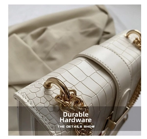 Detailed close-up of white crocodile pattern PU leather bag with durable gold chain links