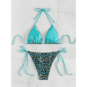 Detailed flat lay of blue halter bikini top and matching leopard print tie-side bottoms