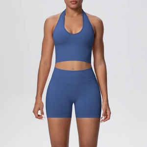 Detail of blue seamless knit yoga set featuring halter neck crop top and high waist shorts