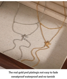 Detail of gold and silver starfish hand chains inside a wooden jewelry box