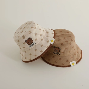 Detail of baby corduroy bucket hats with bear embroidery and textured ribbed fabric