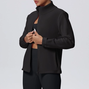 Detail of black slim-fit high-neck sports jacket with smooth zipper and ribbed cuffs