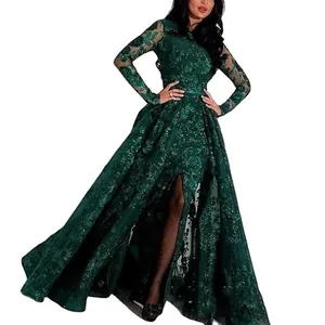 Detail of emerald green lace evening gown with gold sequins and elegant high slit