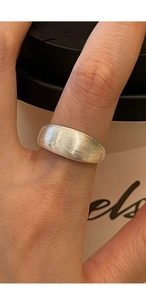 Close-up of S925 sterling silver ring featuring a brushed matte texture on the wide band