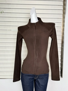 Detail of a brown mock-neck zip-up thermal fleece sweatshirt on a model for casual wear