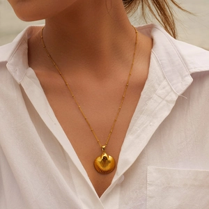 Elegant gold-tone stainless steel shell pendant necklace on a delicate beaded chain